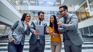 A woman shakes hand with her colleague