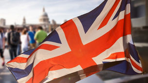A flag of the UK with a busy background