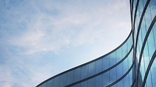Perspective of high rise building and dark steel window system with clouds reflected on the glass.Business concept of future architecture,lookup to the angle of the building corner. 3d rendering