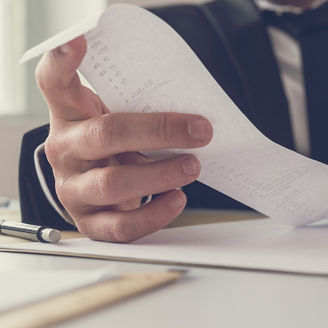 Man in a suit looking a long ticket