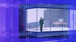 Man looking out in business building