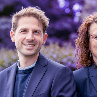 Smiling man and woman with glasses