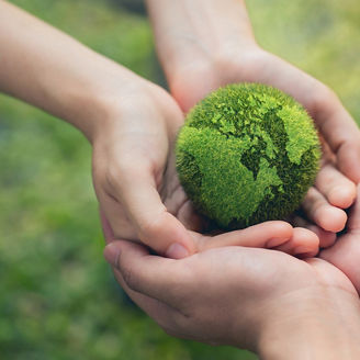 Earth shaped in green hold by hands