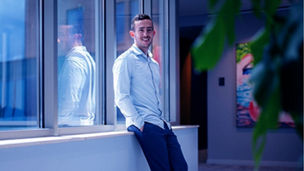 man leaning to office window