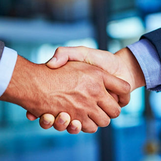shaking hands while closing a deal