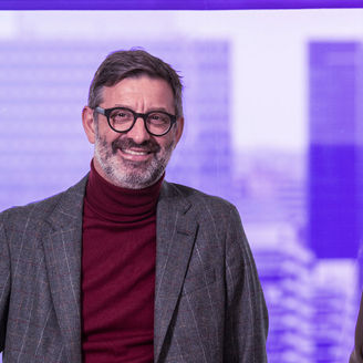 Man in glasses and woman smiling while wearing profesionnal outfits