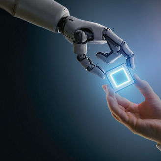 Robotic hand and human hand holding a glowing microchip 