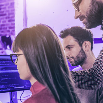 woman wearing glasses looking at her computer