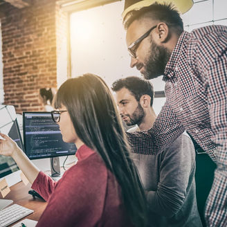 Woman showing code to her colleagues