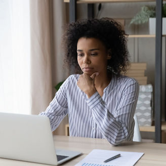 Woman working on her laptop at her desk