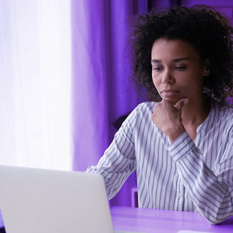 Woman working on her laptop at her desk