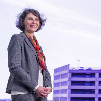 Kathy Lim and Muriel Narmon standing in front of the KPMG building
