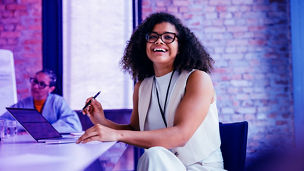woman smiling at desk