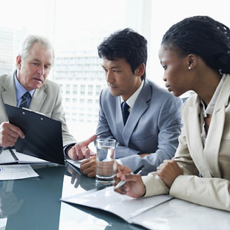 Two employees attentively listening to their director