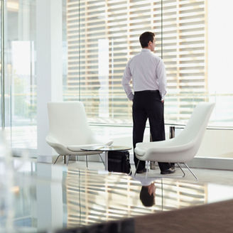 Man looking out office window