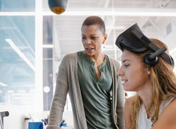 Women colleagues working on one laptop