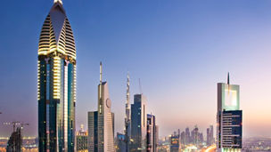 traffic zooming along a busy highway as sunsets in Dubai