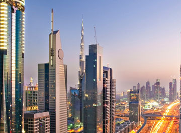 traffic zooming along a busy highway as sunsets in Dubai