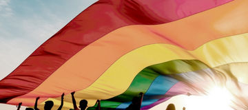 People with rainbow flag on pride parade