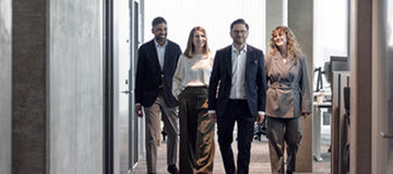 Four people walking towards the camera