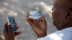 Farmers demonstrate how they receive payements from Northern Farming using their mobile phones and a credit card system near MasIvingo, Zimbabwe Tuesday, Aug. 5, 2014.  Northern Farming has received a grant from the Africa Enterprise Challenge Fund, which is run by KPMG/ IDAS, that has allowed it to support rural farmers by providing them with information via text messages and workshops, fertiliser, and better seeds. Northern Farming then buy their produce off them and resell it on the commercial market. 