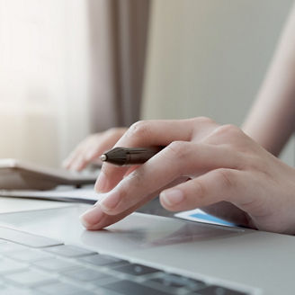 Close up of businessman or accountant hand holding pencil working on calculator to calculate financial data report, accountancy document and laptop computer at office, business concept