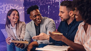 Two girls and two boys smiling and talking to each other