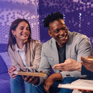 Two girls and two boys smiling and talking to each other