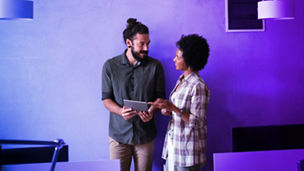 Two people looking at tablet