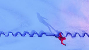 Aerial view of man silhouette shadow balancing on the metal construction in beach, Klaipeda, Lithuania.