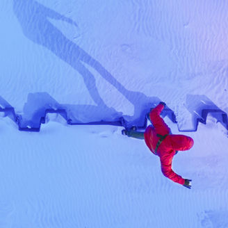 Aerial view of a man walking in snow