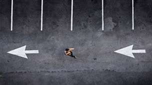 Aerial view of Pacific Islander woman running in parking lot