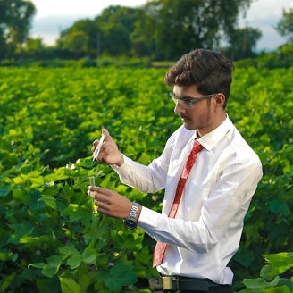 Young indian agronomist with test tube, Agriculture and scientist concept.