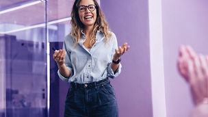 Accomplished team leader receiving an applause from her colleagues at the end of her business presentation. Successful businesswoman smiling happily, celebrating her hard work with her team.; Shutterstock ID 2398222029; purchase_order: Advisory assurance; job: anne; client: Future of audit campagne