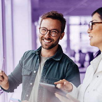 Business man brainstorming with his colleague using sticky notes. Creative business people standing next to a window and discussing their ideas.; Shutterstock ID 2371350991; purchase_order: Advisory assurance; job: anne; client: Future of audit campagne