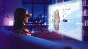 Woman with VR-glasses is navigating the web for a new trenchcoat.