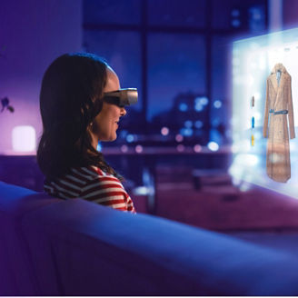 Woman with VR-glasses is navigating the web for a new trenchcoat.