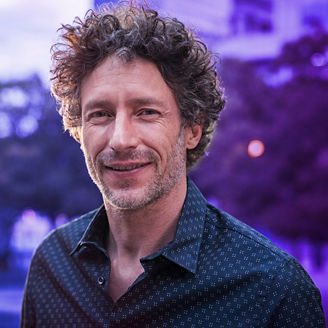 Portrait of happy mature man looking at camera outdoor. 
