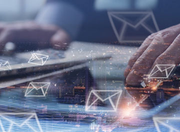 Digital marketing, Email campaign, newsletter, direct sales business strategy concept. Double exposure of business man sending email via digital tablet, laptop computer and smart city with e-mail icon