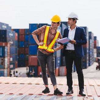 Smart creative foreman and engineer woman control loading containers box from cargo freight ship for import export. Logistic, transportation, import and export concept. With copy space.
