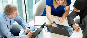 People sat around a table in an indoor office space