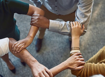 People hold each other by the elbows