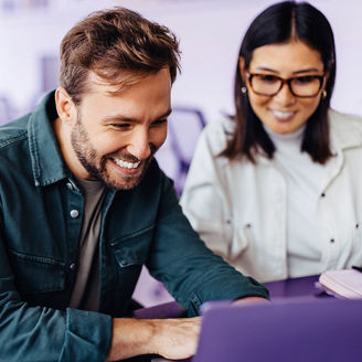 Successful business man using a laptop in a meeting with his colleague. Happy business man playing a slideshow presentation in an office.; Shutterstock ID 2304643873; purchase_order: marketing advisory assurance; job: Anne; client: AI campagne