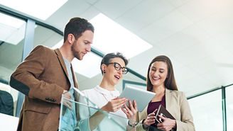 Group, people and conversation with tablet in modern office for lens flare, collaboration and reading report. Tech, agency and team by railing with idea discussion and strategy planning for meeting.