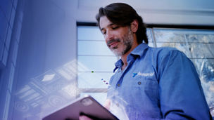 Ausgrid technician looks at procurement data on an AI assistant built with KPMG's KymChat 