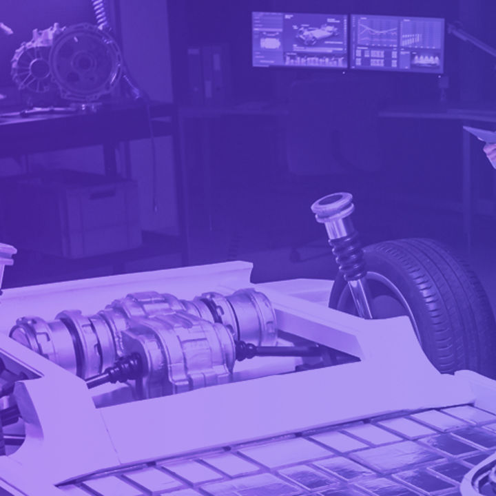 People standing around car substructure