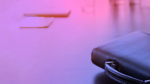 A person looking at a laptop on a desk with digital graphics