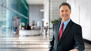Corporate banking advisor, professional investment manager, businessman, greeting with welcoming smile in building lobby