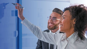Two colleagues working with whiteboard