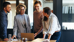 Group of business people having a meeting in a tech company. Creative business professionals planning a project in an office. Teamwork and collaboration in a modern workplace.